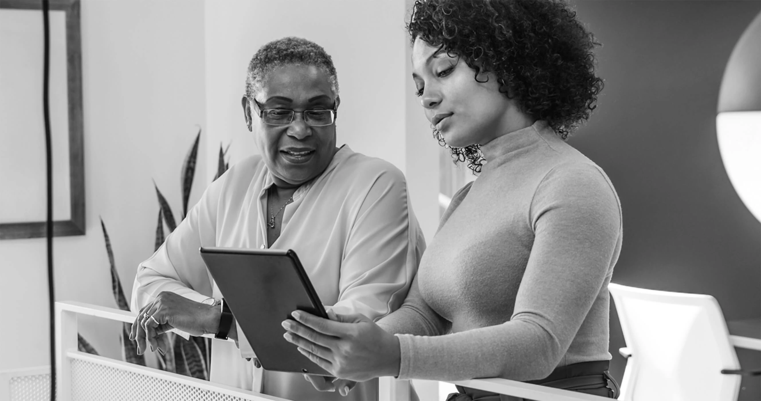 Two colleagues looking at a business plan