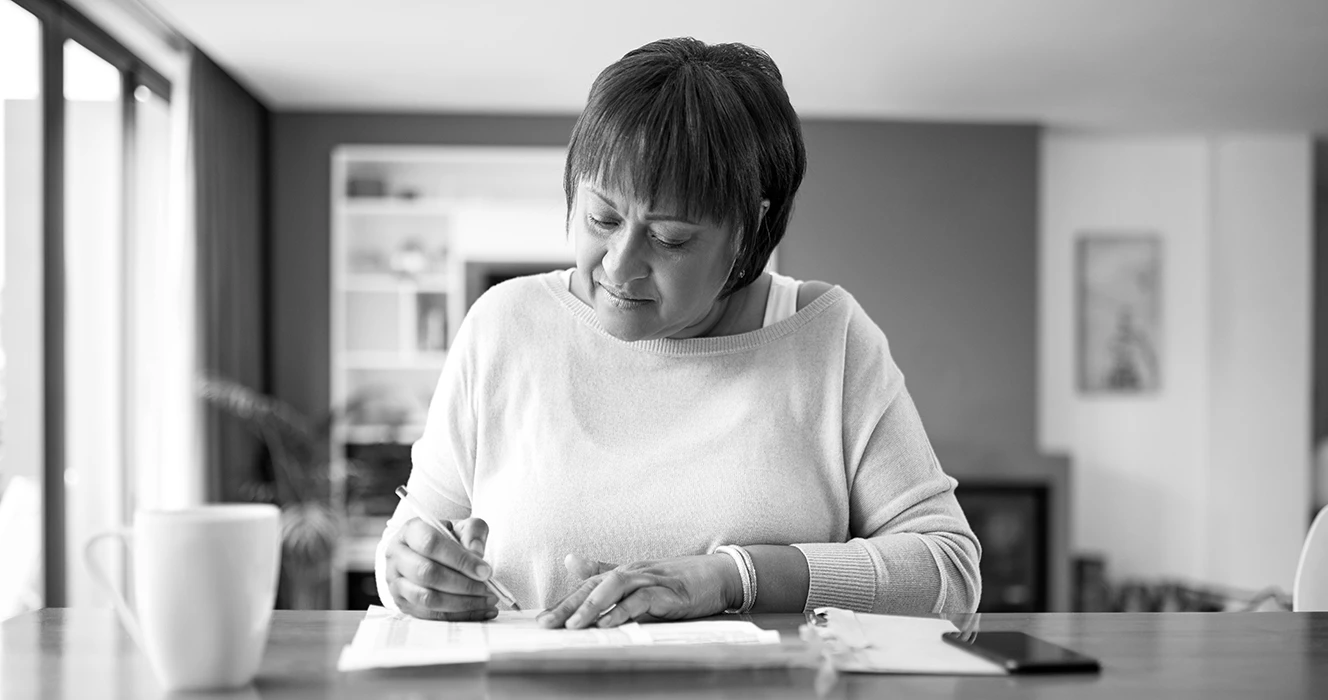 A woman working on her financial paperwork